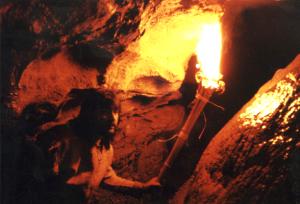Benjamin Raven Pressley exploring cave with a torch