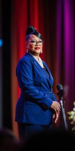 Dr. Velma Bagby is standing in blue suit