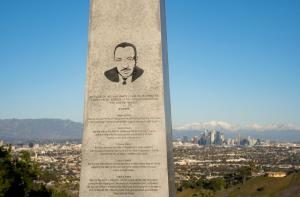 A monument displays part of Martin Luther King Jr.’s “I Have a Dream” speech, overlooking the city skyline