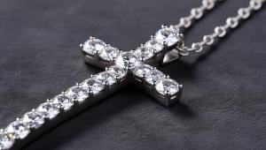 A cross necklace with diamonds.