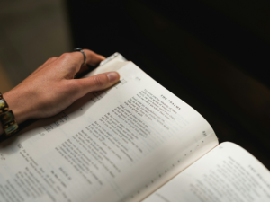 Unseen person holding a Bible