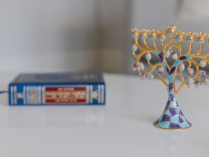 a decorative Menorah next to a hebrew bible