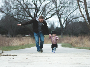 Dad skipping with his little girl