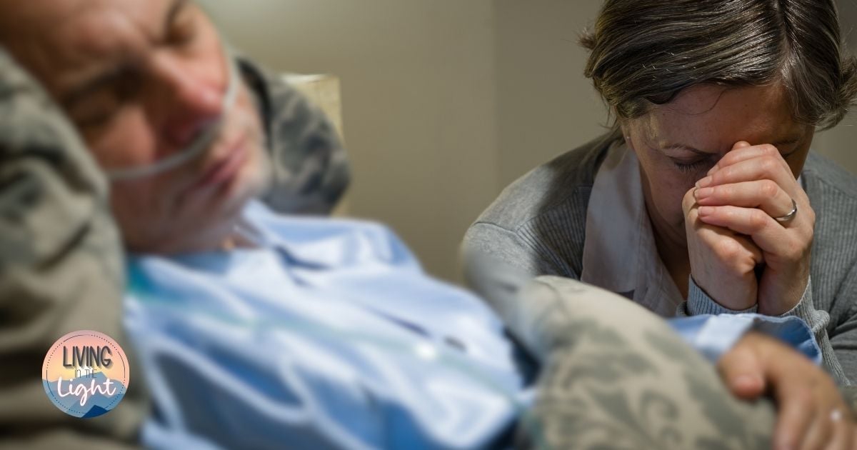 A woman praying beside a loved one who is gravely ill, symbolizing faith, prayer, and hope in God’s presence during cancer and extreme illness.