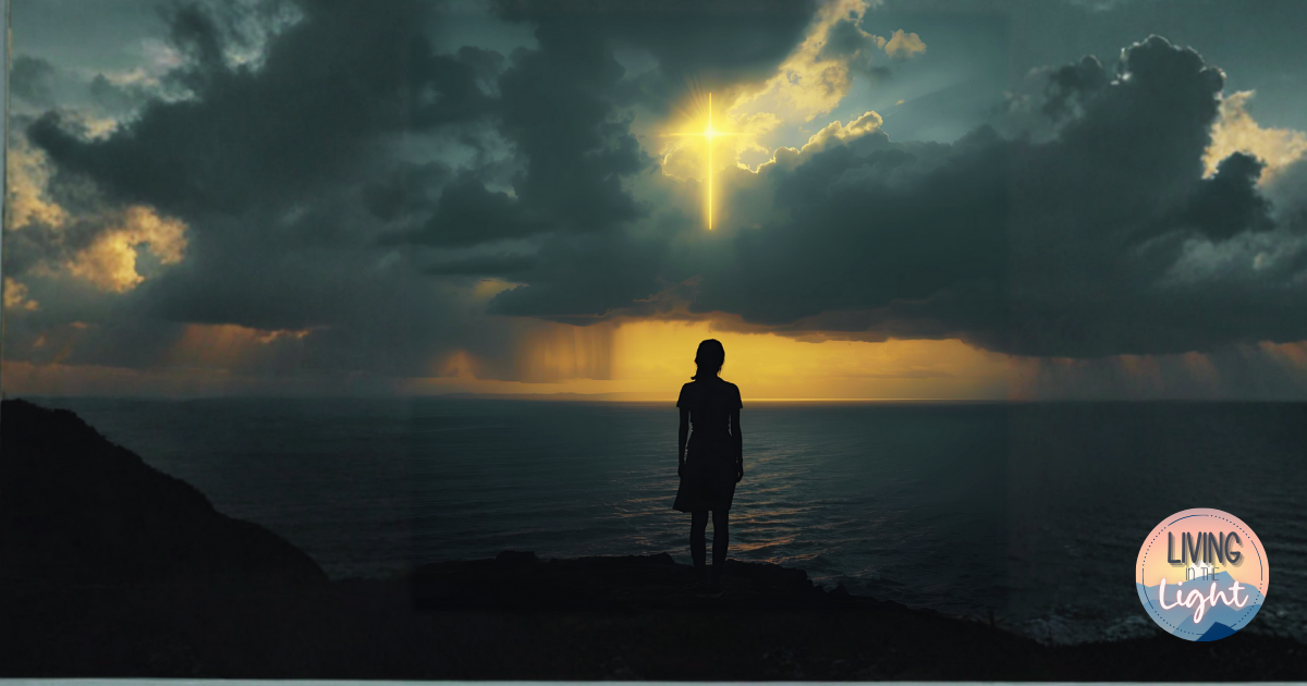 Silhouette of a person standing on a cliff overlooking the ocean beneath storm clouds, with golden sunlight breaking through in the shape of a cross — symbolizing God’s presence and hope in the midst of life’s storms.