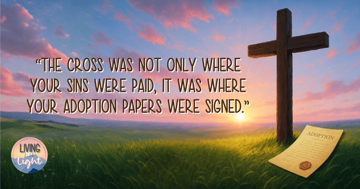 A wooden cross stands in a green field under a bright sunrise sky filled with pink and blue tones. Beside the cross lies a parchment labeled “Adoption.” The image includes the quote, “The cross was not only where your sins were paid, it was where your adoption papers were signed.”