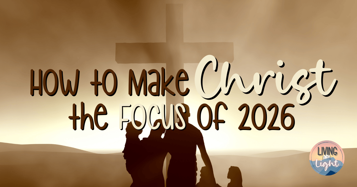 Silhouetted family standing together beneath a large cross at sunrise, symbolizing making Christ the focus of 2026.