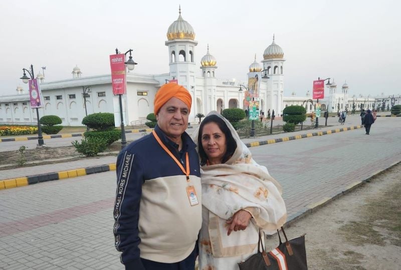 a couple posing in frotn of a temple