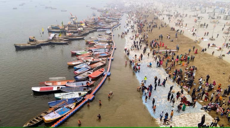 People taking bath in river with boats marooned