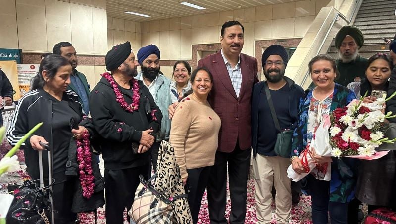 a group of pilgrims with a Pakistani official 