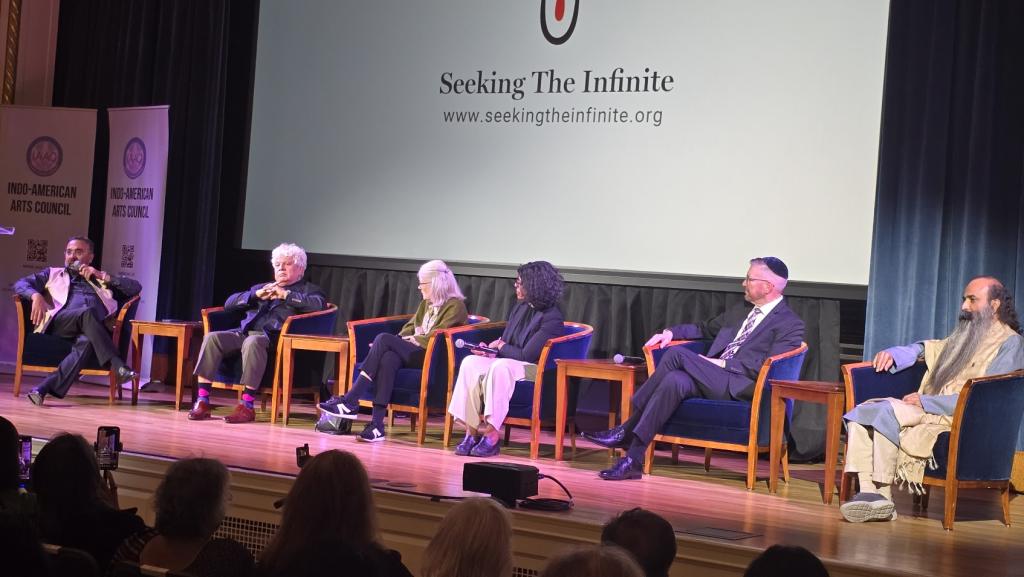 A panel discussion with 6 people on the stage.