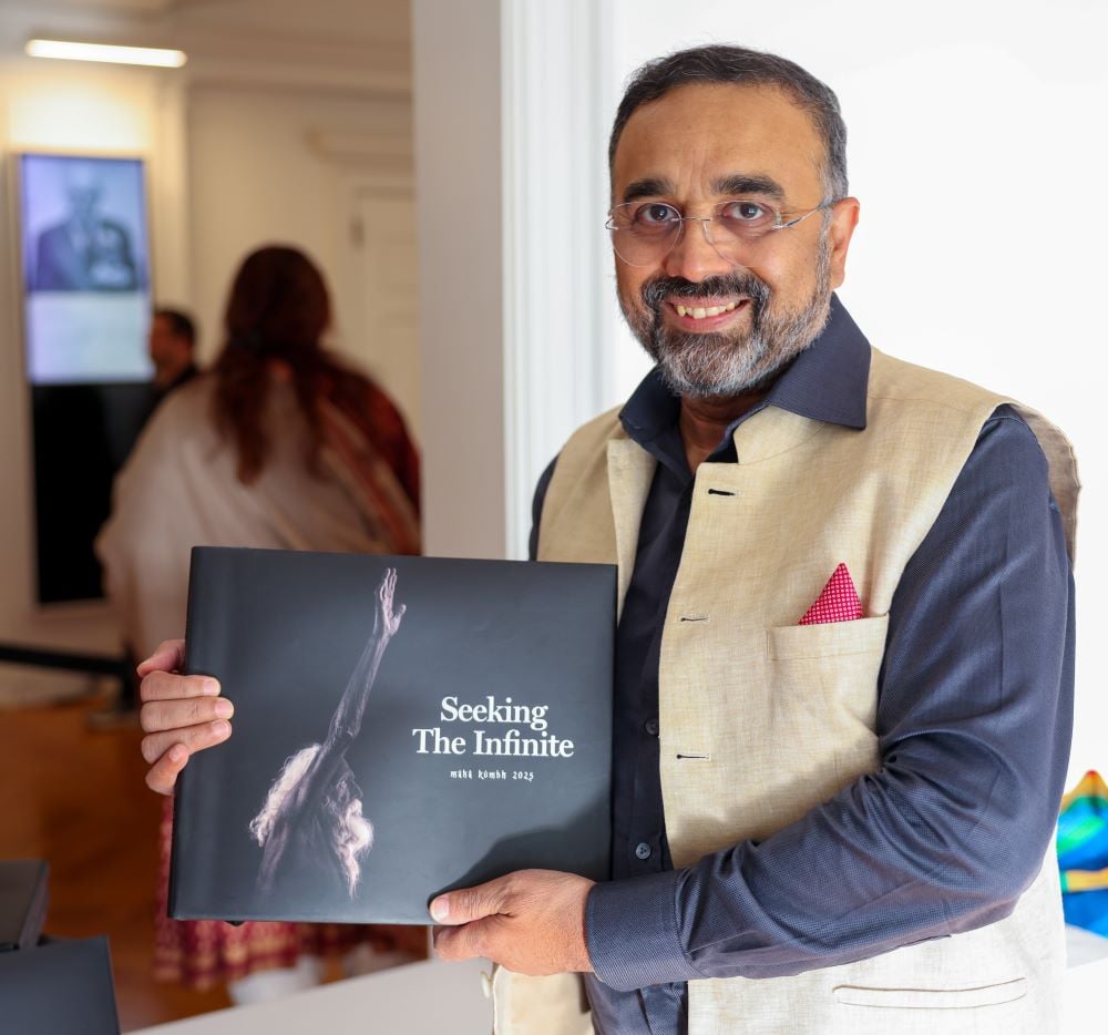 Author showing a copy of his book.