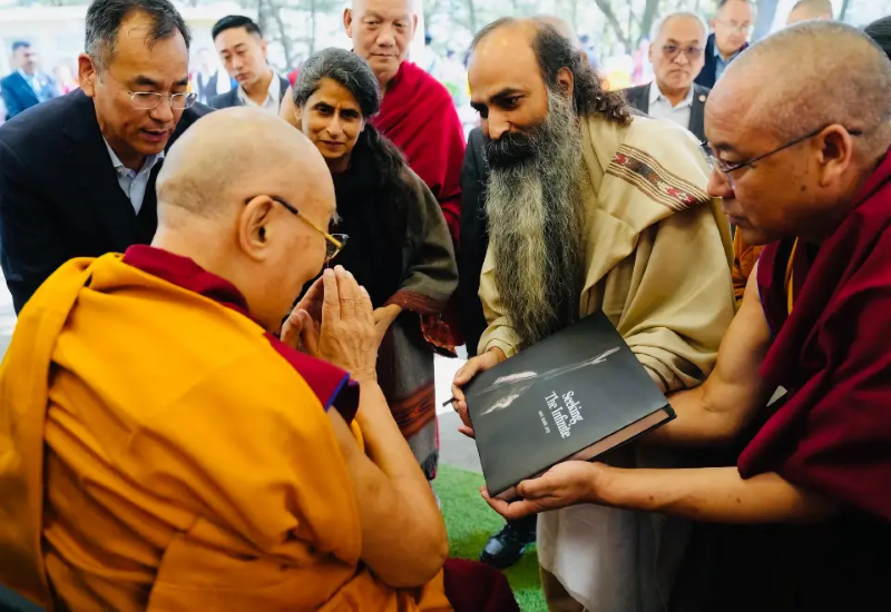 Buddhist monk being presented copy of a group in a group.