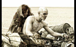 Riley Keough and Nicholas Hoult star in a scene from the movie "Mad Max: Fury Road." (CNS/Warner Bros./Jasin Boland)