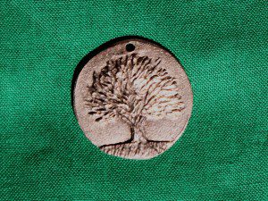“When in doubt, consult your nearest tree” – a medallion that belonged to Isaac Bonewits – it now sits on a shrine of sacred objects