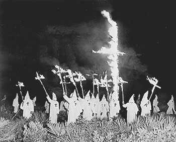 KKK cross burning, Gainesville GA, December 31, 1922. Photo Source: Wikimedia Commons, Public Domain. https://en.wikipedia.org/wiki/Ku_Klux_Klan