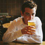 Man drinking pint of beer in pub