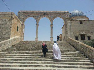 Tayyibah Taylor (in white) ascending the steps of the Dome of the Rock.