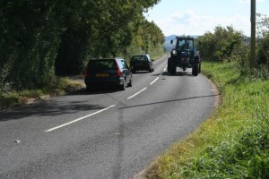 Tractor with Cars Passing