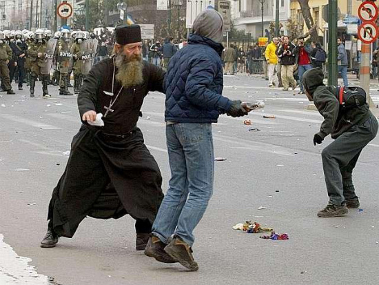 priest rioters Priest intervenes with between police and rioter