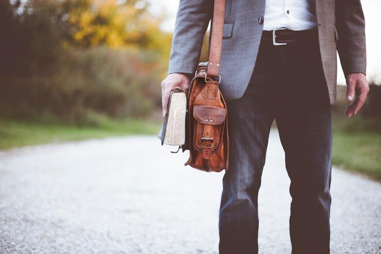 Man with Bible and laptop bag