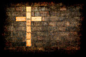 cross of christ built into a brick wall