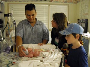 New dad Noé, aunt Maura, uncle David and baby Robert in 2009.