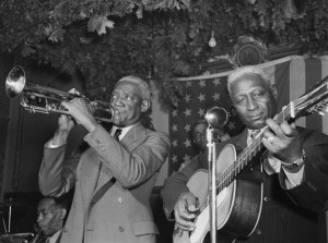 "Bunk Johnson, Leadbelly, George Lewis, Alcide Pavageau (Gottlieb 04541)" by William P. Gottlieb - This image is available from the United States Library of Congress's Music Division under the digital ID gottlieb.04541.This tag does not indicate the copyright status of the attached work. A normal copyright tag is still required. See Commons:Licensing for more information.العربية | čeština | Deutsch | English | español | فارسی | suomi | français | magyar | italiano | македонски | മലയാളം | Nederlands | polski | português | русский | slovenčina | slovenščina | Türkçe | українська | 中文 | 中文（简体）‎ | 中文（繁體）‎ | +/−. Licensed under Public Domain via Wikimedia Commons - https://commons.wikimedia.org/wiki/File:Bunk_Johnson,_Leadbelly,_George_Lewis,_Alcide_Pavageau_(Gottlieb_04541).jpg#/media/File:Bunk_Johnson,_Leadbelly,_George_Lewis,_Alcide_Pavageau_(Gottlieb_04541).jpg
