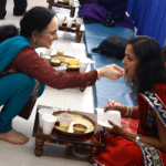 Jain educator Darshana Shah offers a celebratory spoonful to a friend and fast-breaker.