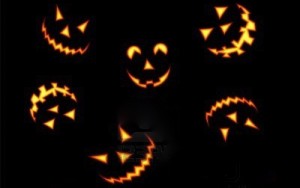 5563097-halloween-pumpkin-faces-lit-brightly-on-black-background