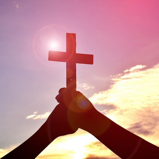 Faith-Christian-Cross-Hands-Sky-Sun-Glare_credit-Shutterstock