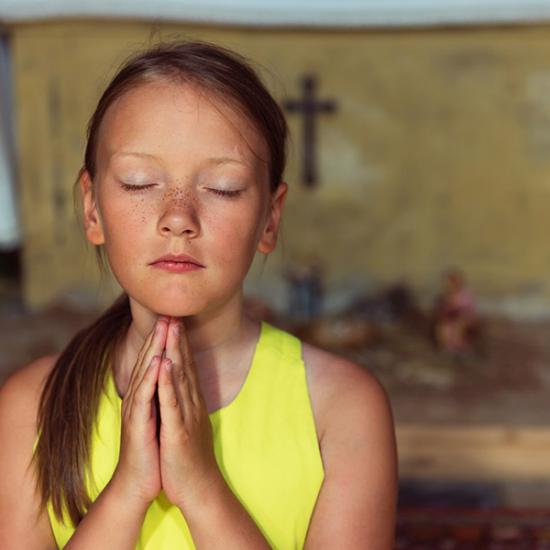 girl-praying-at-church_credit_shutterstock.com
