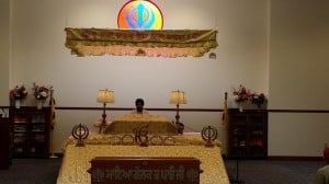 the takhat in Gurdwara Nanak Darbar and an attending priest