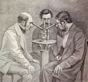 Men looking through microscope