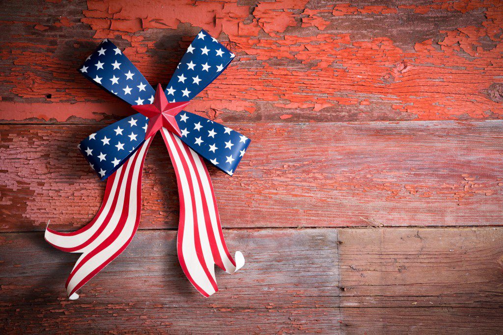 Indepedence Day 4th July emblem with a blue stars bow and curly red and white ribbon to celebrate the Declaration of Independence of the Untited States of America