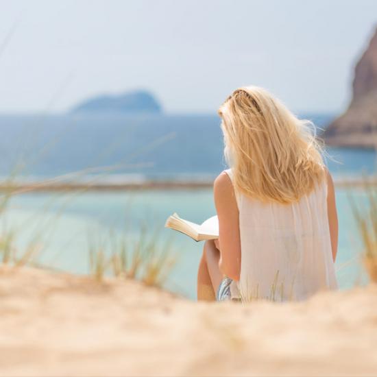 Woman-Reading-Bible-Ocean_credit-Shutterstock.com