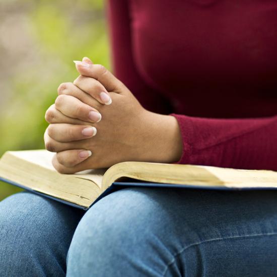 woman-praying-bible_credit-Shutterstock.com