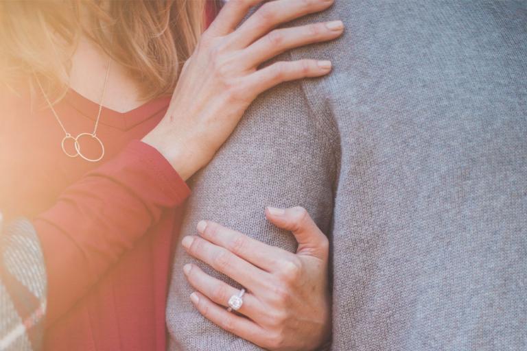 Wife holding her husband's arms