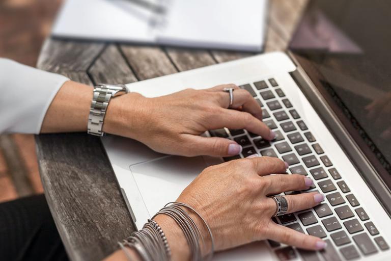 Image of woman typing on a laptop at a desk