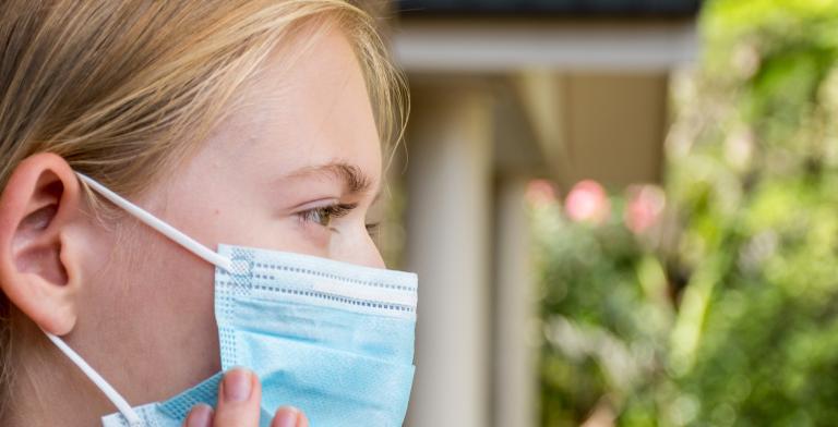 woman wearing disposable face mask to prevent the spread of viruses