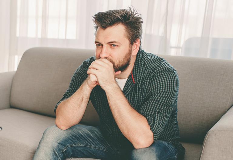 Frustrated man on sofa - When You Tease Your Husband, It’s Really No Joke