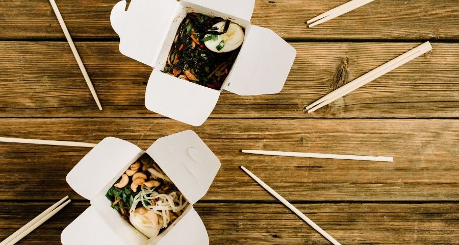 Two Chinese food takeout containers on a table