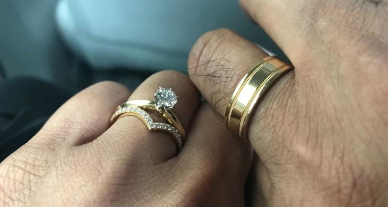 Closeup photo of a wedding bands on a man and woman's hand