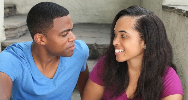 African American couple sits and talks to one another