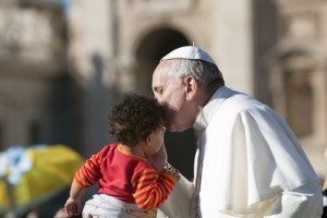 Pope Francis kissing a child