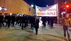 The Author, walking with Brennos of the Coru Cathubodua, Oakland, Nov 24, 2014. We formed a small buffer zone between the initial phalanx of police and the rest of the march. Many more police – in full riot gear – were to come.  photo by Gay Sidhe