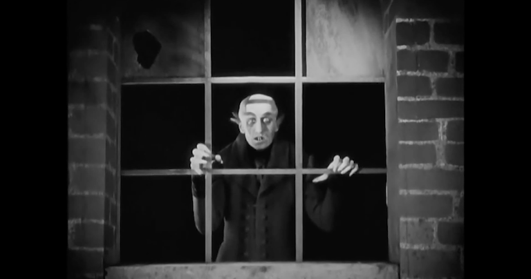 vampire leans out of window