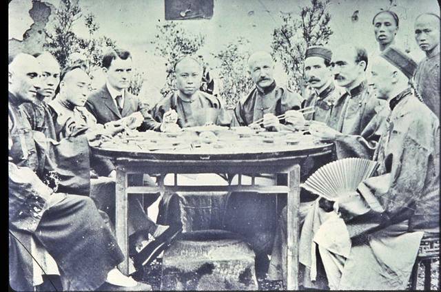 Group of Chinese and missionary men at a feast