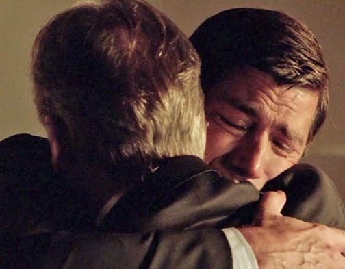 father and son hugging crying