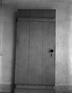 Image: black and white photo of a closet door.